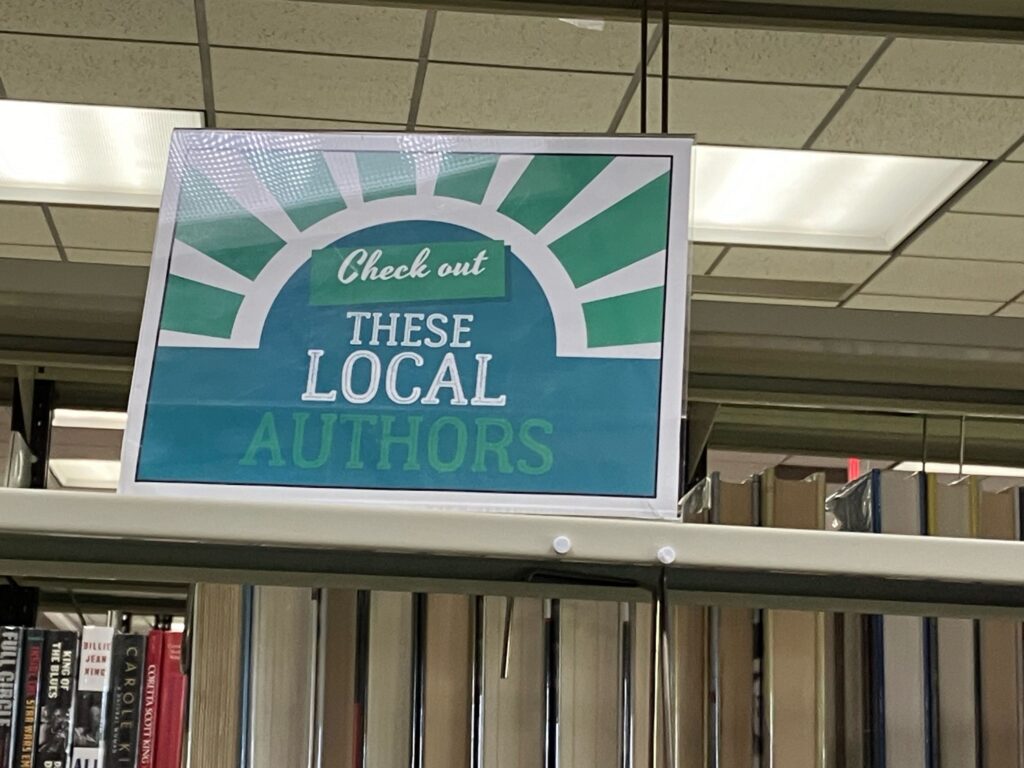 The Local Author Section is by the Women's Restroom at the back right side of the library